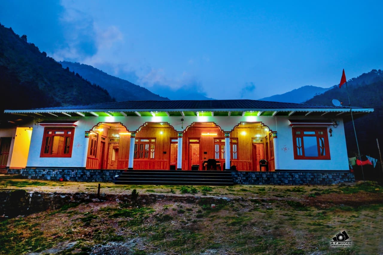 homestay facade with mountains in the backdrop